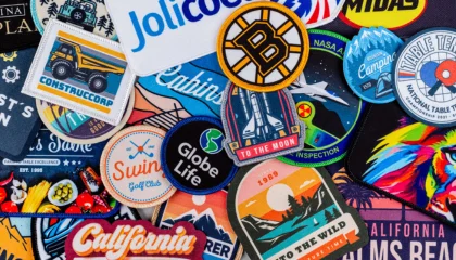 Close up comparison between a fuzzy chenille patch and a flat detailed woven patch.