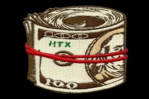 Digitized embroidery pattern of a rolled stack of 100 dollar bills secured with a red rubber band.