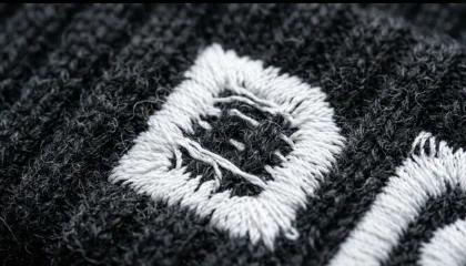 fabric showing through white embroidery on beanies close up