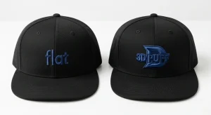 Cap flat logo vs cap 3D puff logo side by side on two identical black structured baseball caps